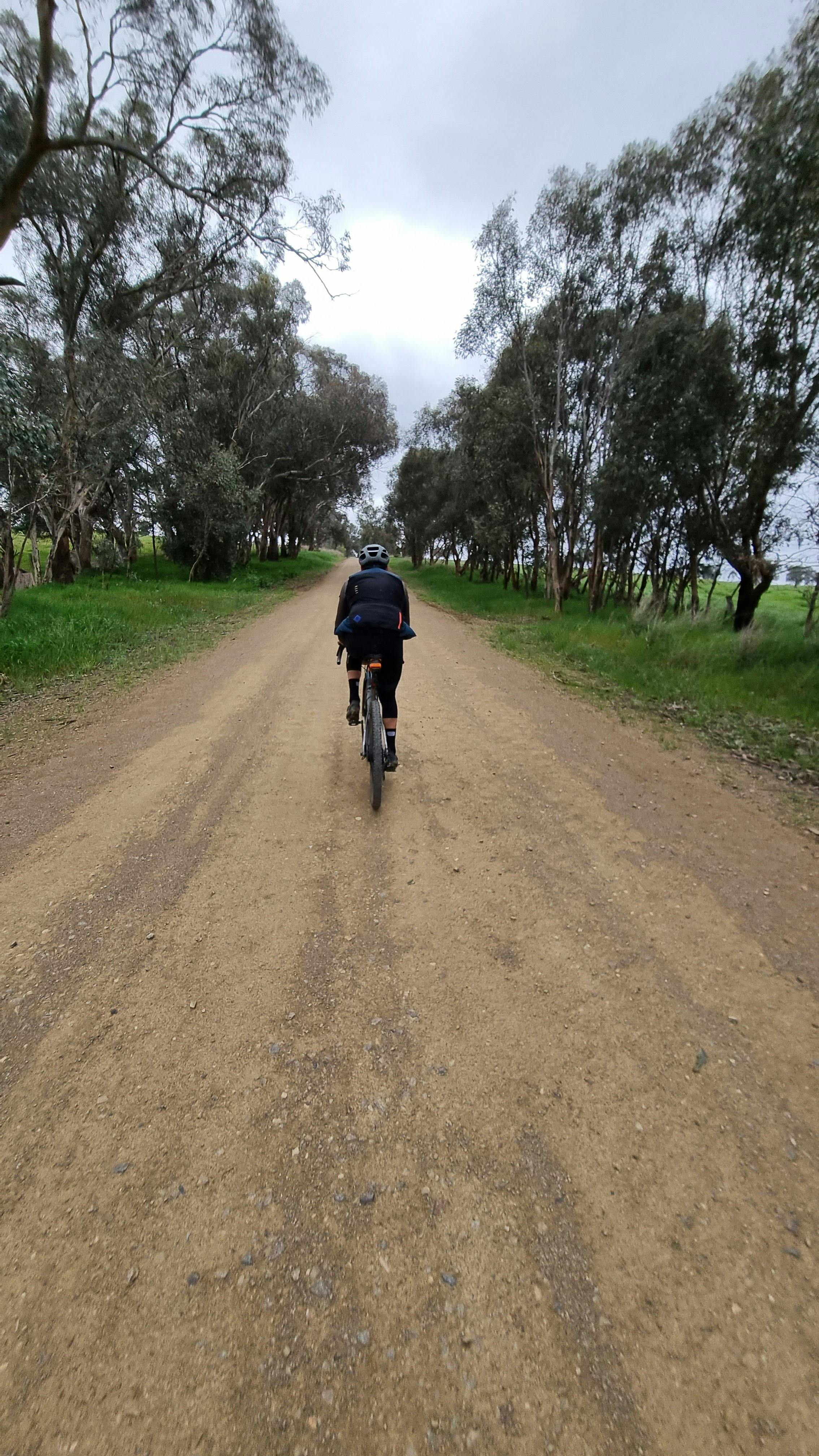 Cyclist on Gravel Road