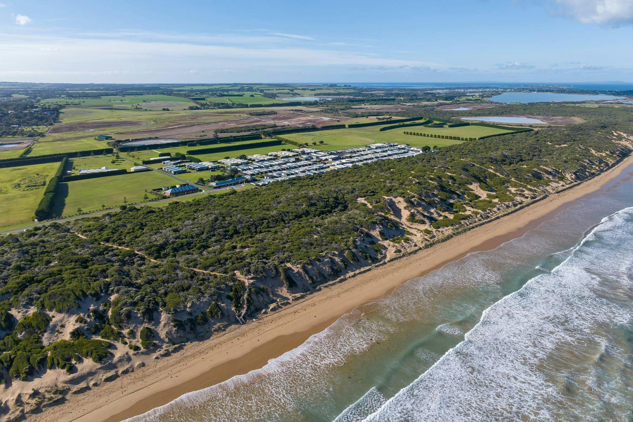 Aerial view of Collendina Holiday Park looking inland from the ocean.