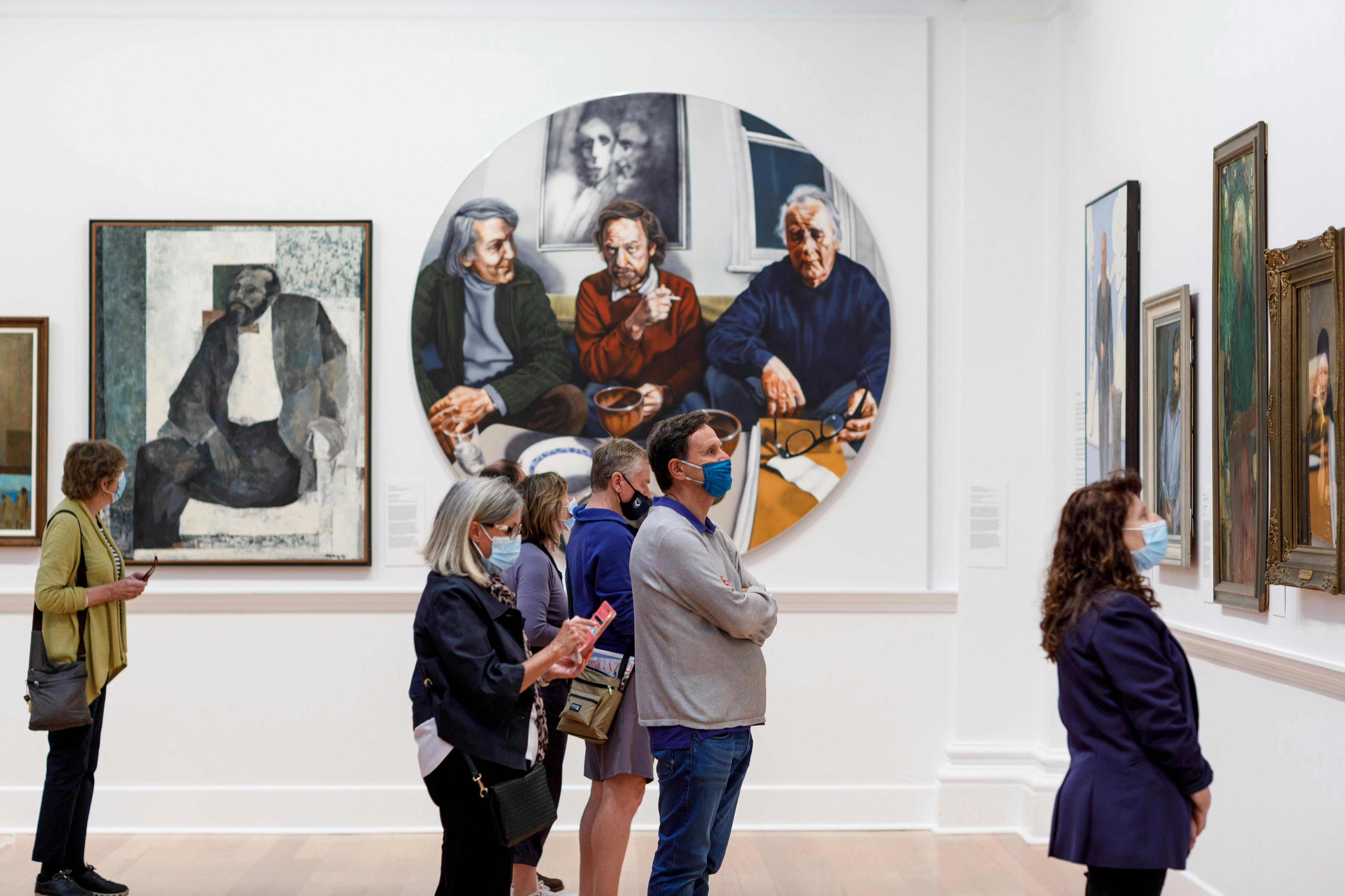 Visitors looking at paintings on the walls of Geelong Gallery