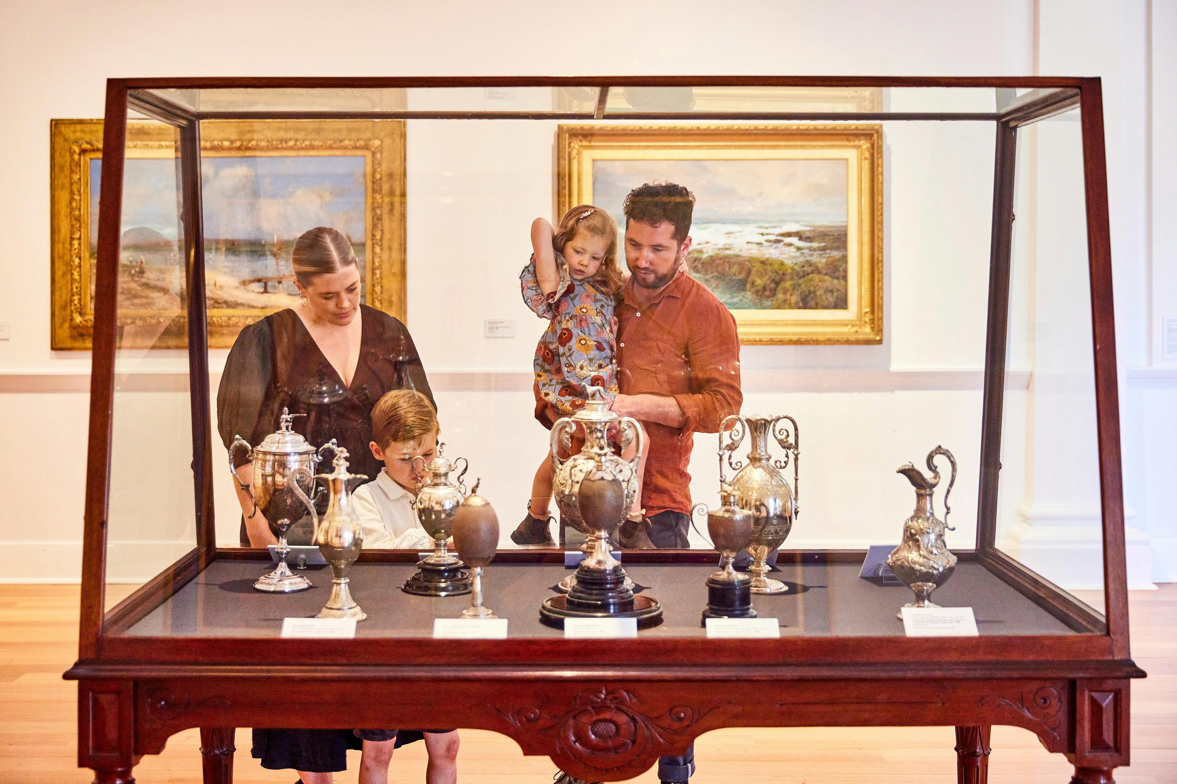 Young family looking at decorative art display at Geelong Gallery