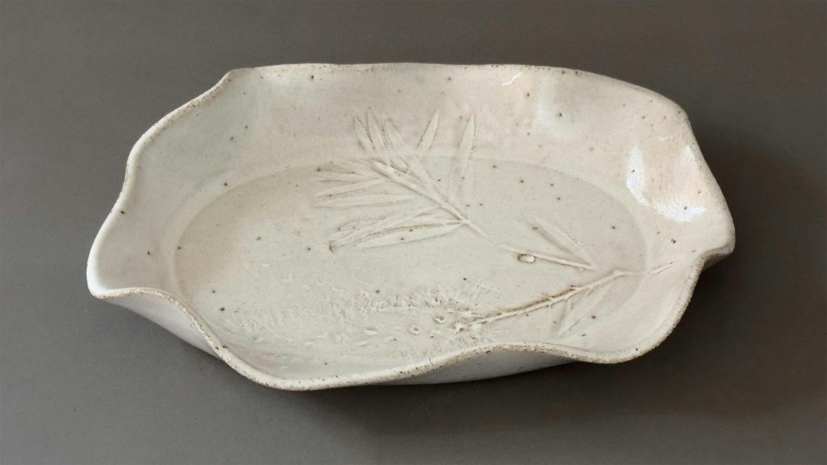 A hand-made ceramic plate with botanical impressions, made at one of our 'Plate & Platter" workshops