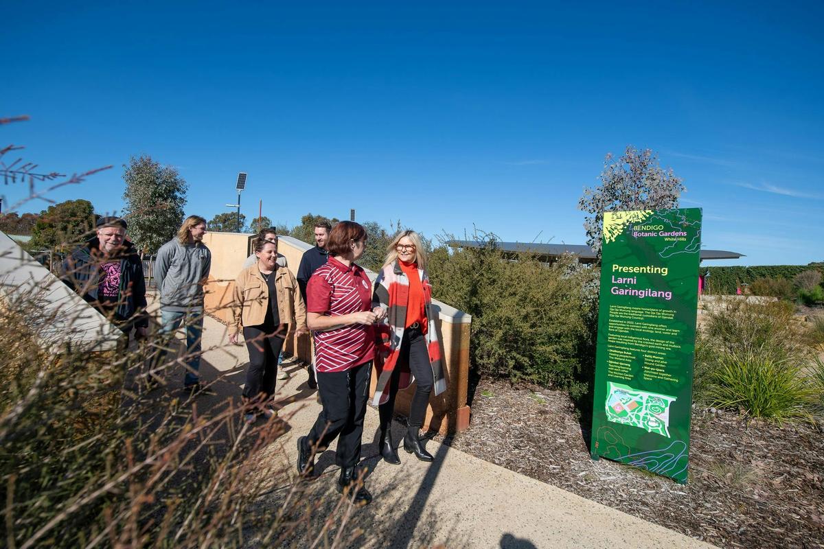 Dumawul tour guide leading group through gardens