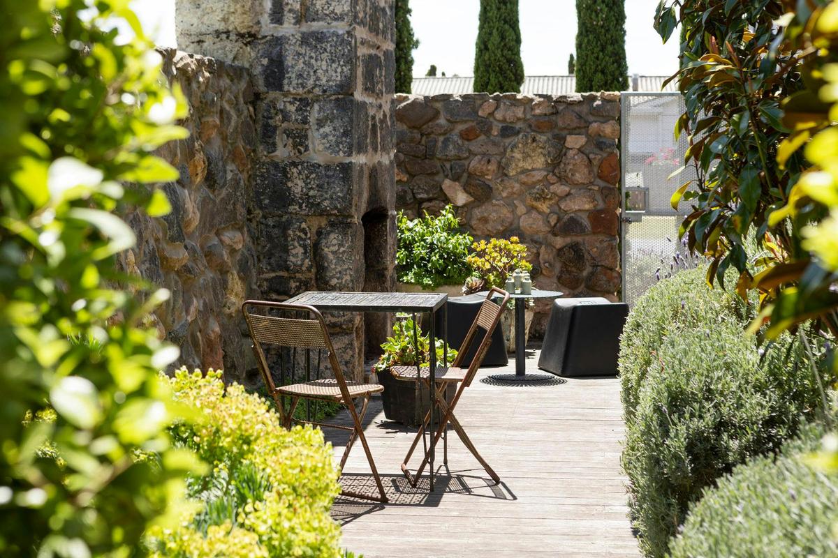 Suite 3 courtyard with open fireplace and dining