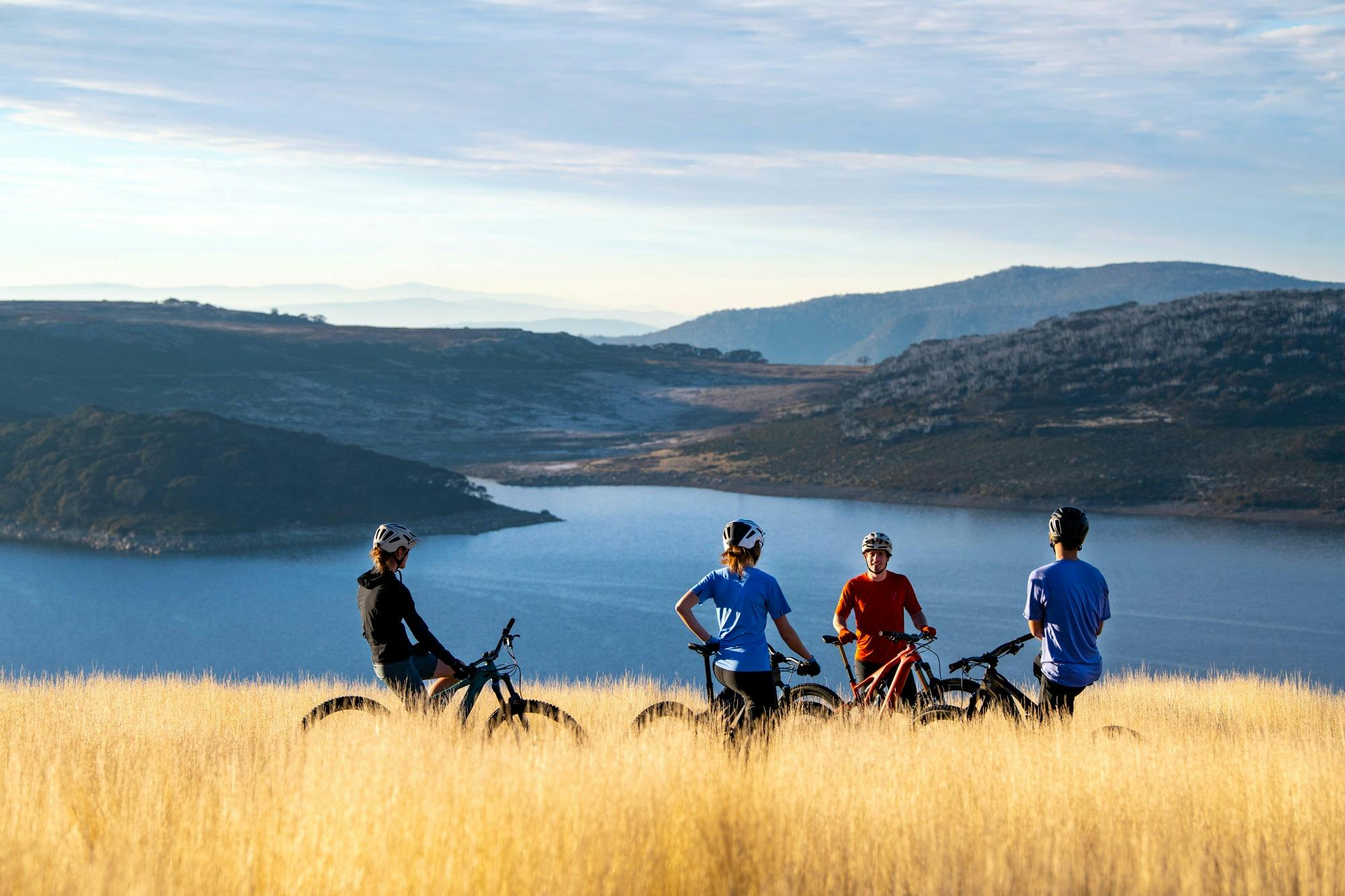 A group of cyclists by Rocky Valley Lake at Falls Creek in the green season