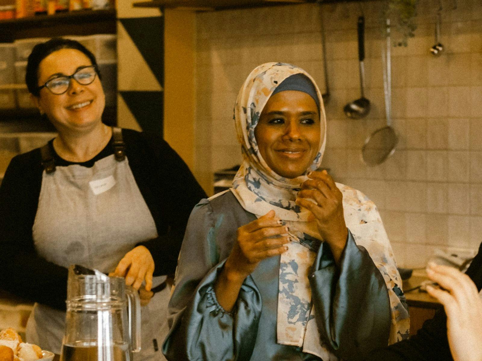 Two women smiling at cooking class