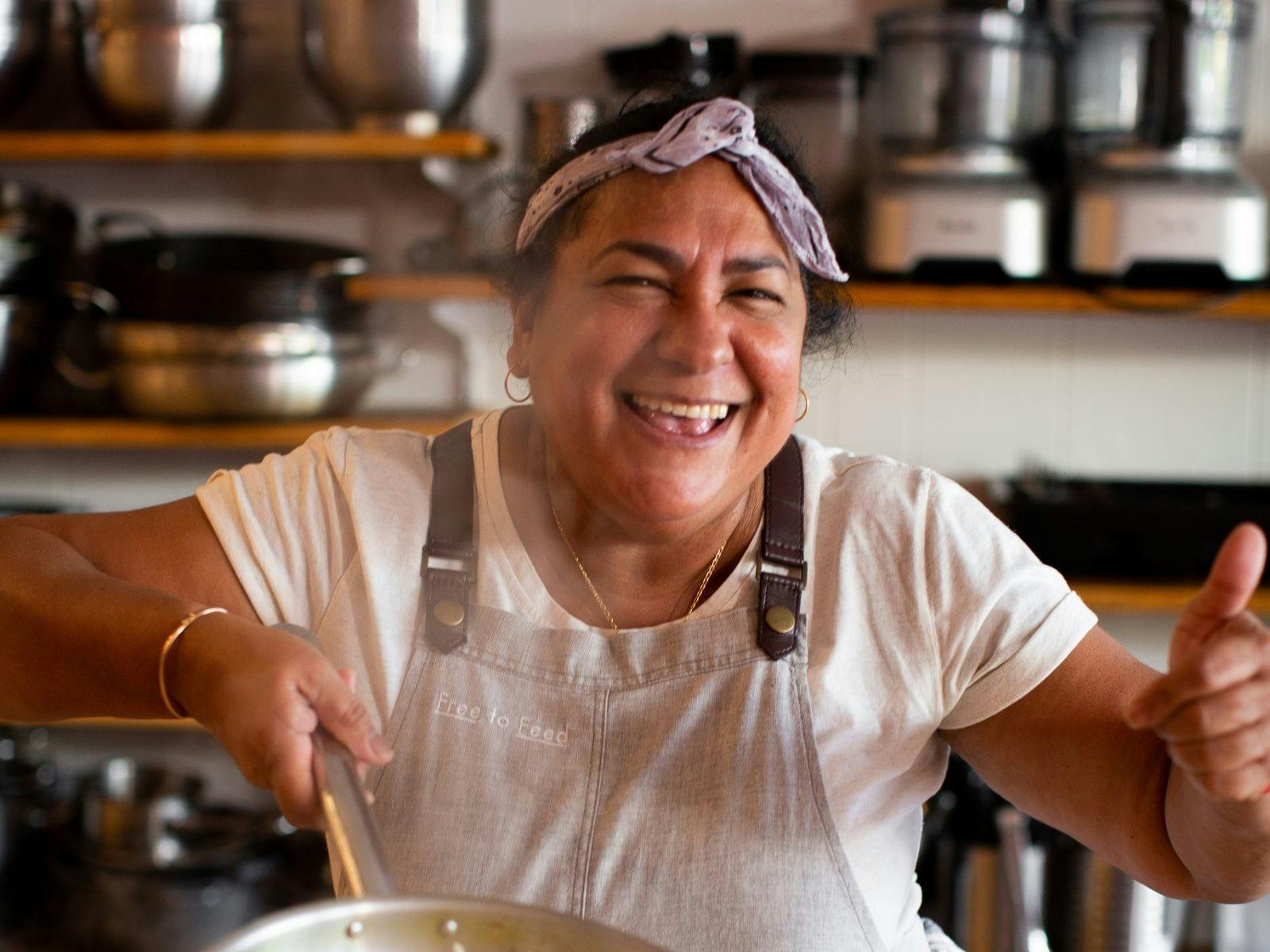 Woman smiling with pan at class