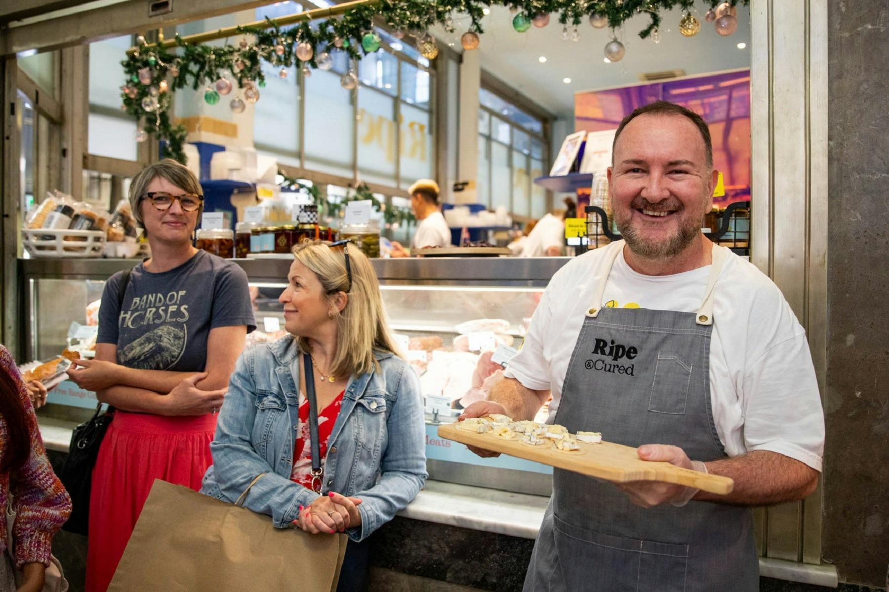 A food tour with a chef showing a plate of food to visitors