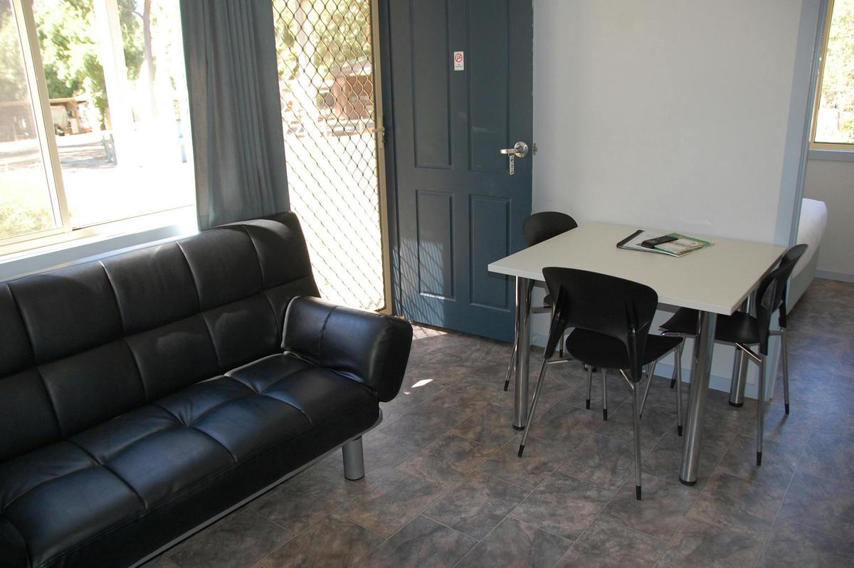 Room with a couch and dining table and chairs