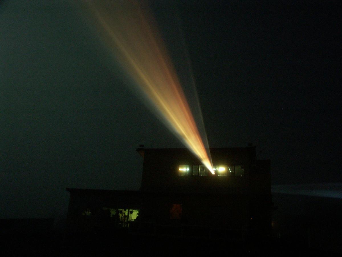 Night, projector beam through night sky