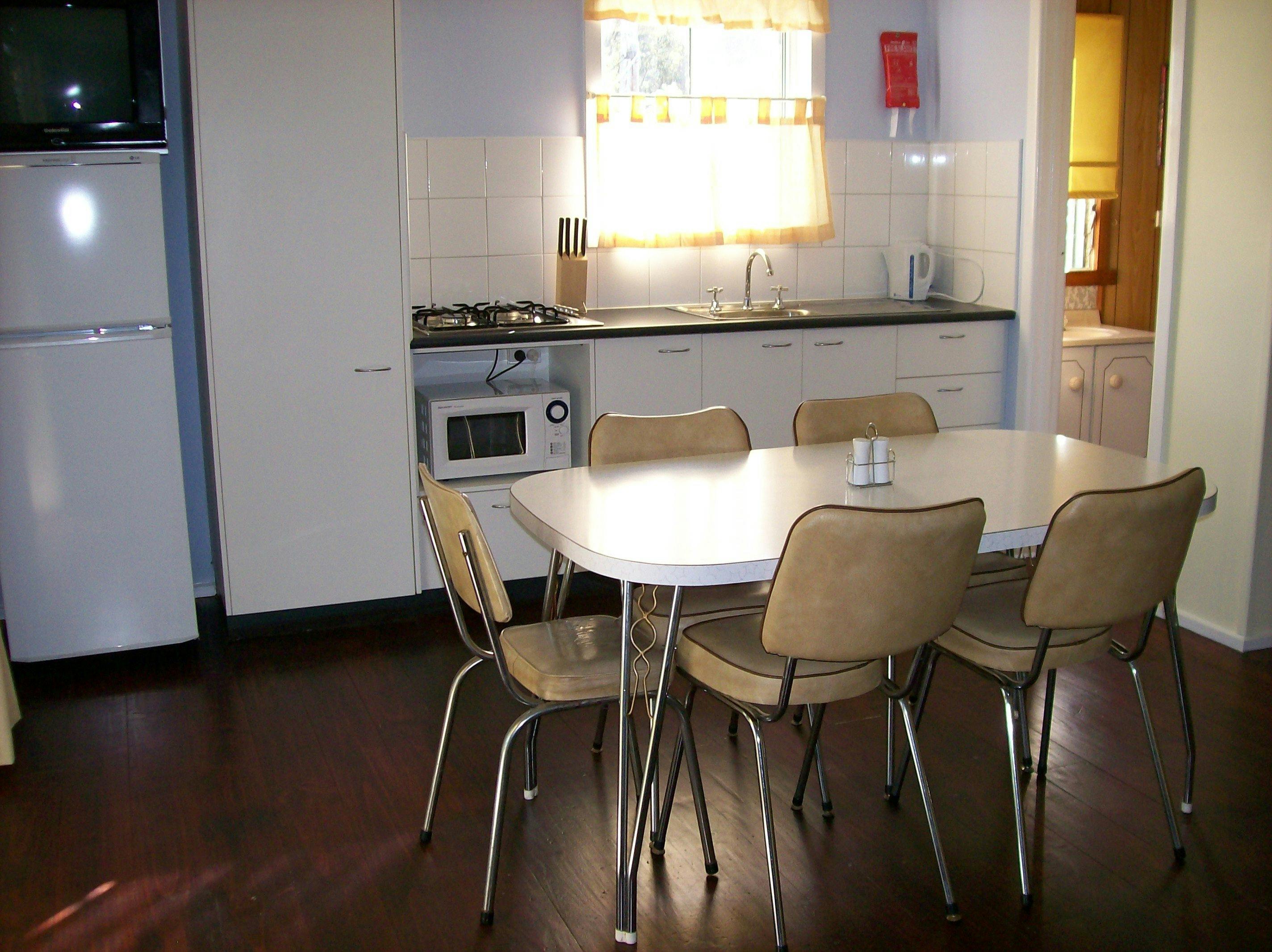 Self contained kitchen with stove top, microwave and full size fridge