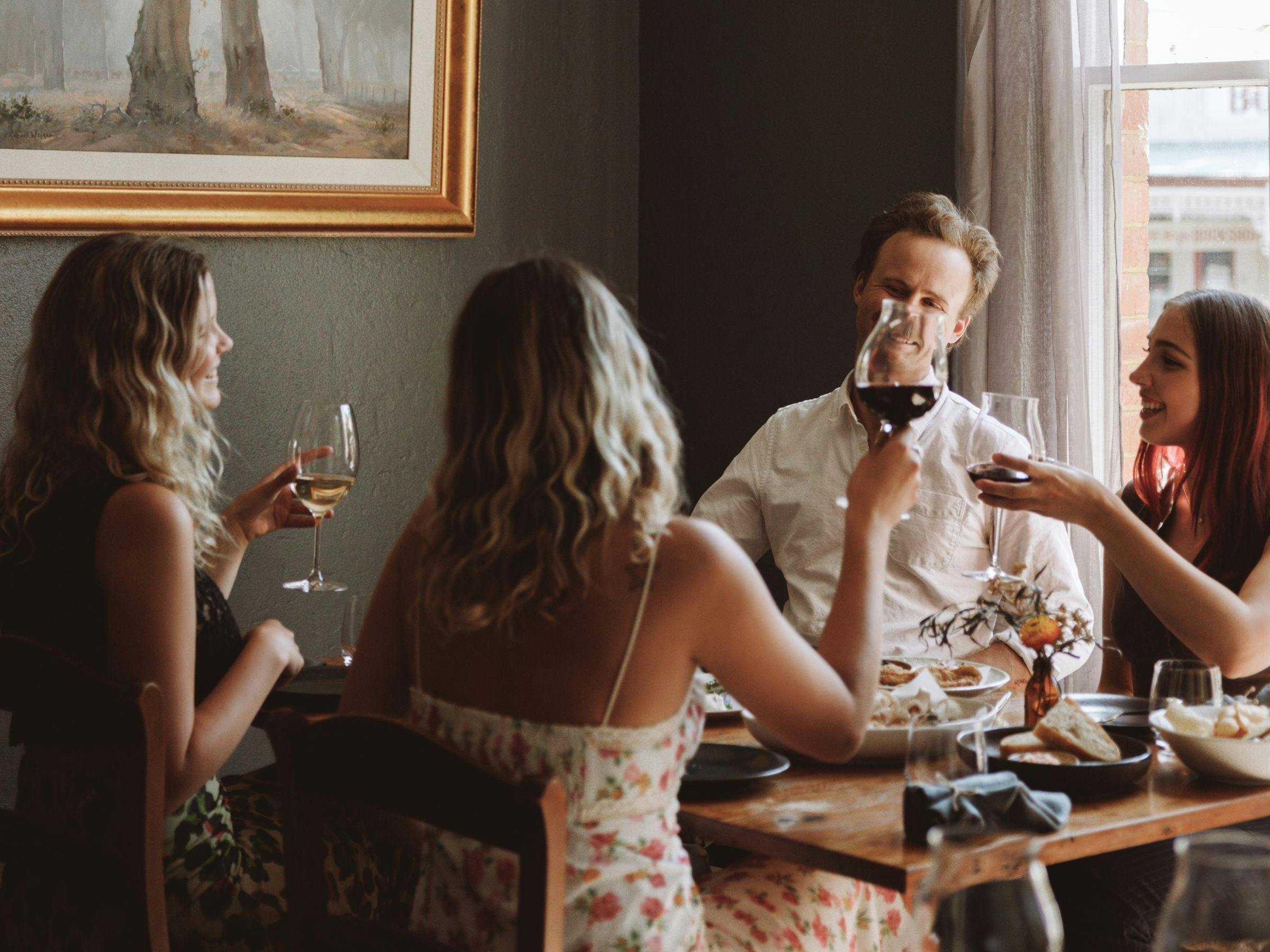 An image of friends enjoying dinner at Elm Dining