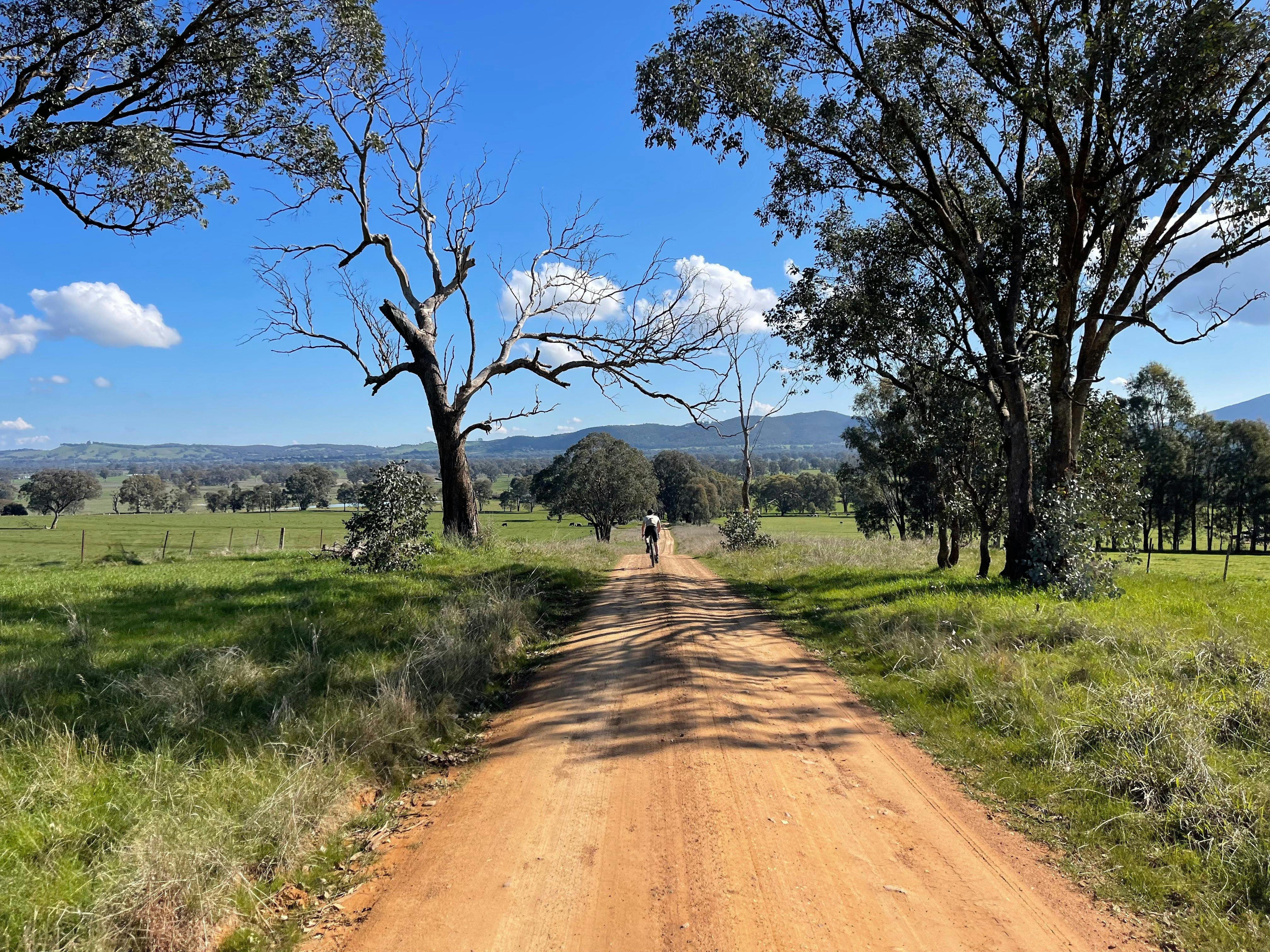 Gravel road cyclist in distance