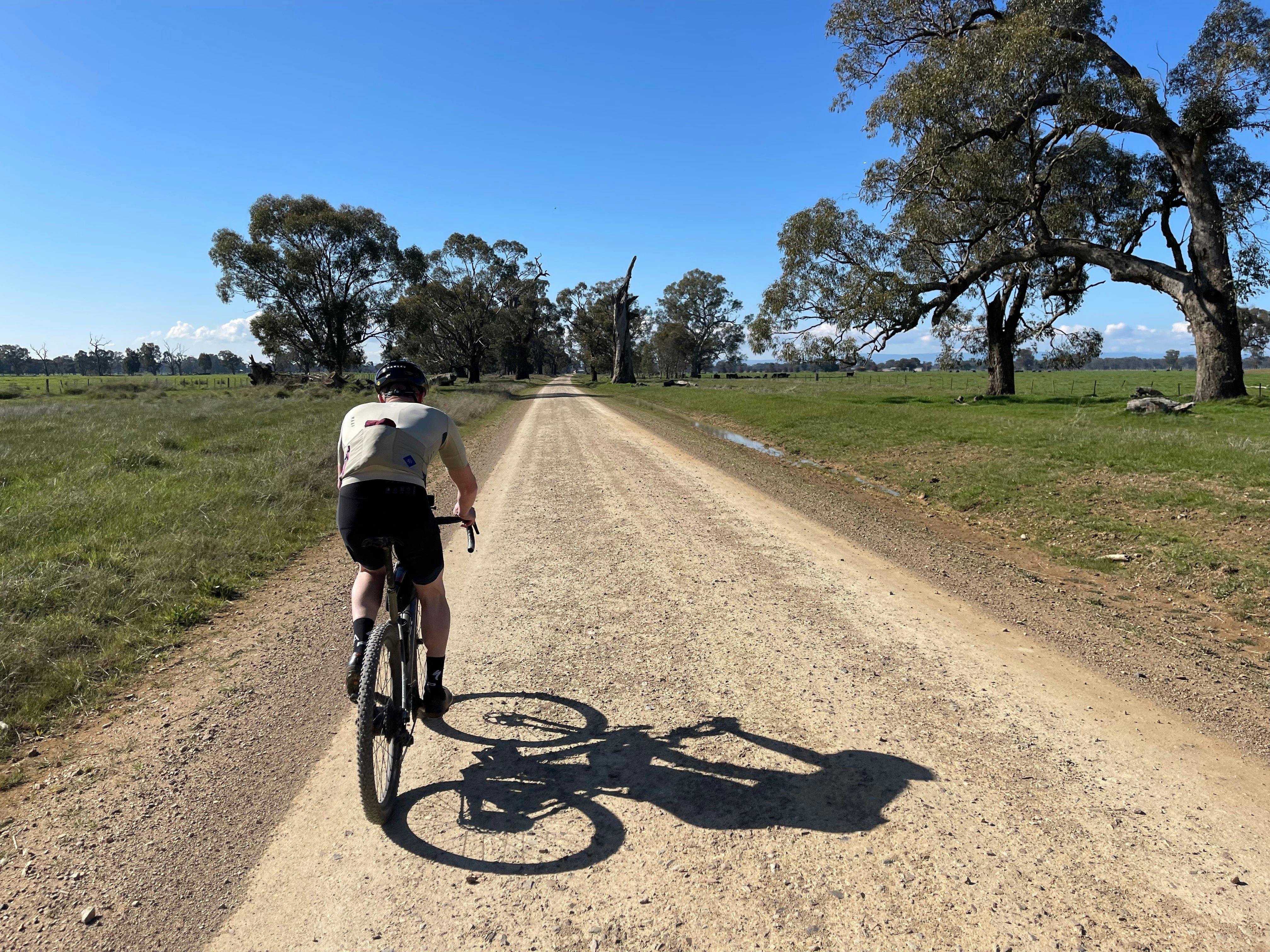 Cyclist on Gravel Road