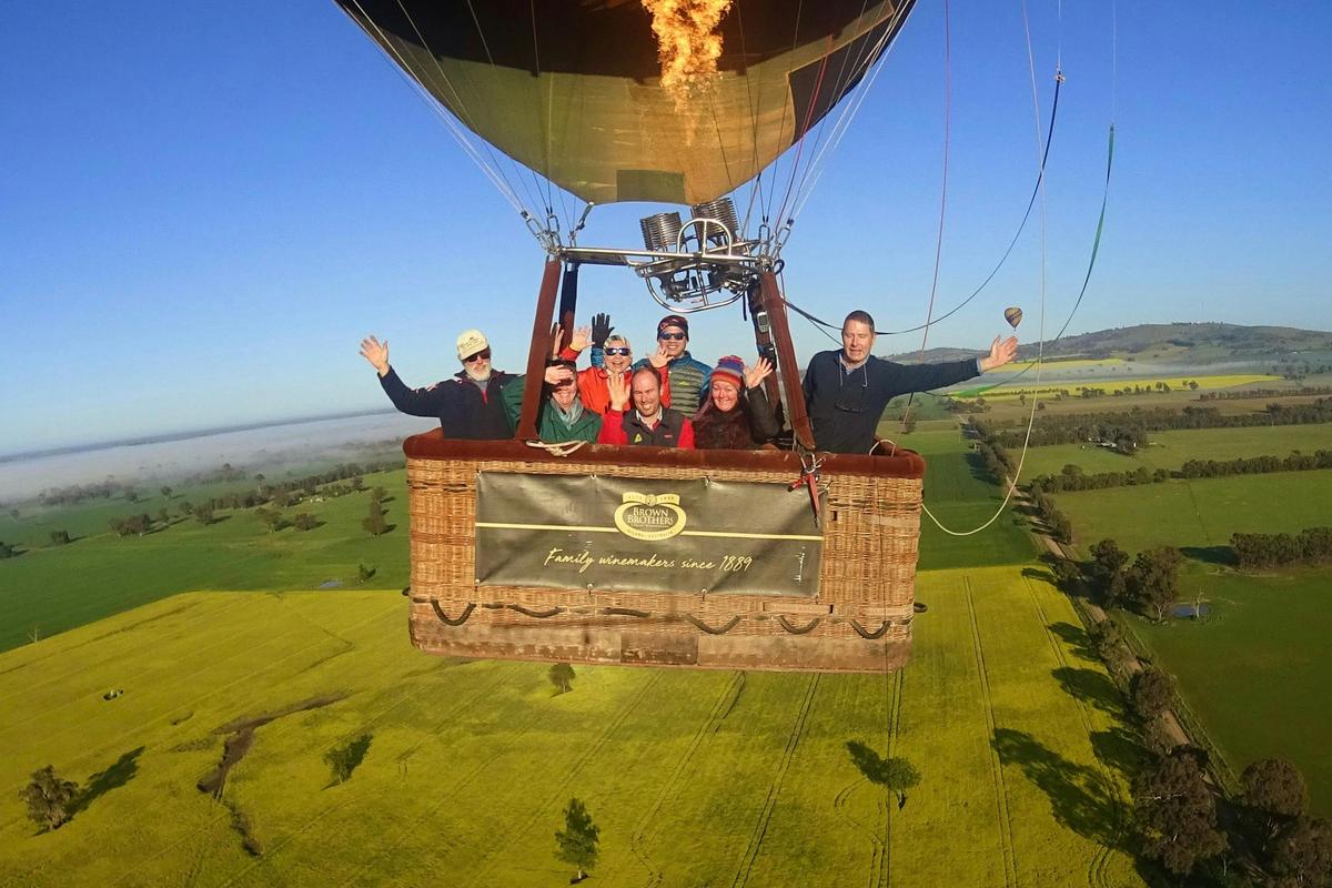 Balloon basket with guests aloft over the canola fields