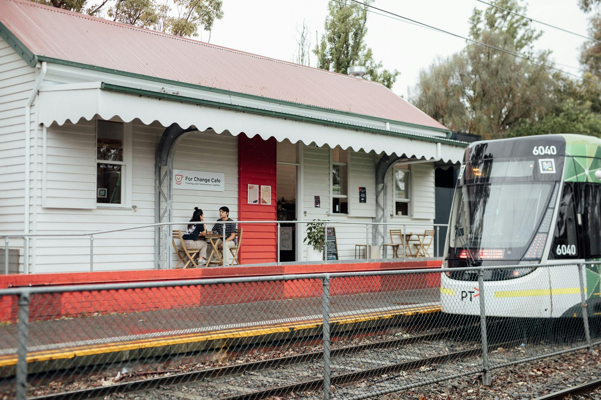 Outside of For Change Cafe with the tram