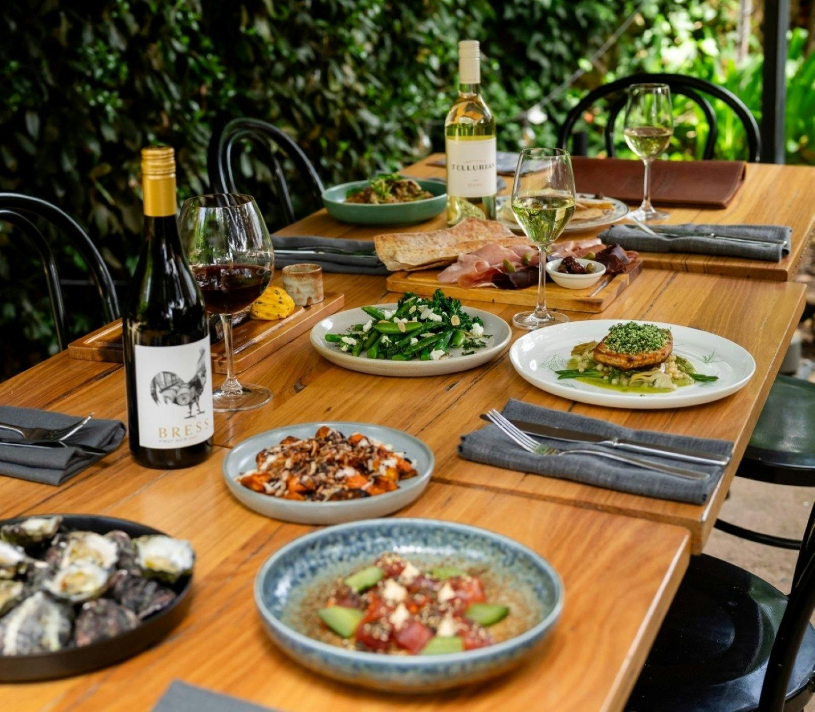 Dishes and glasses of wine placed on a table