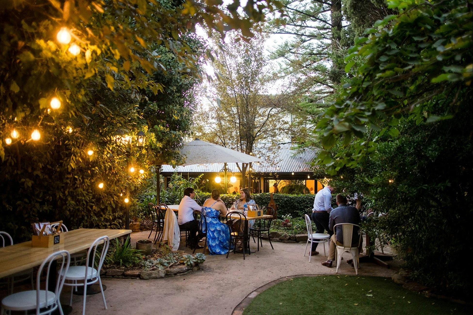 outdoor seating area with fairy lights on trees