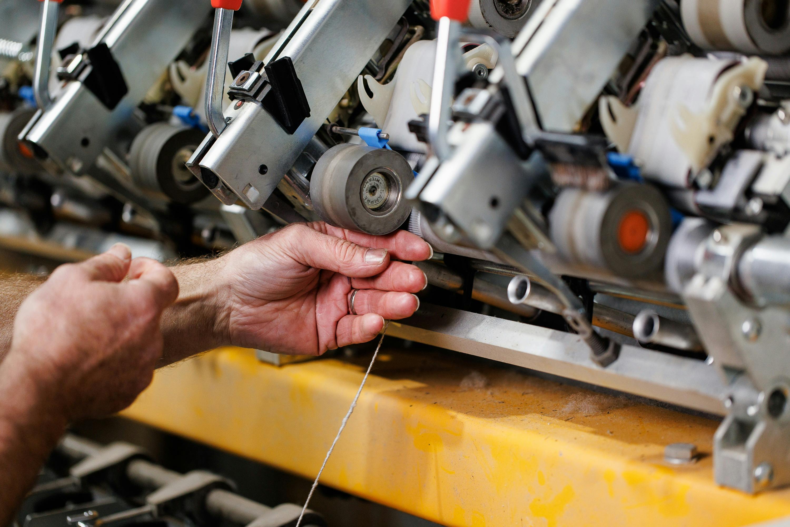 2 hands are setting up a spinner