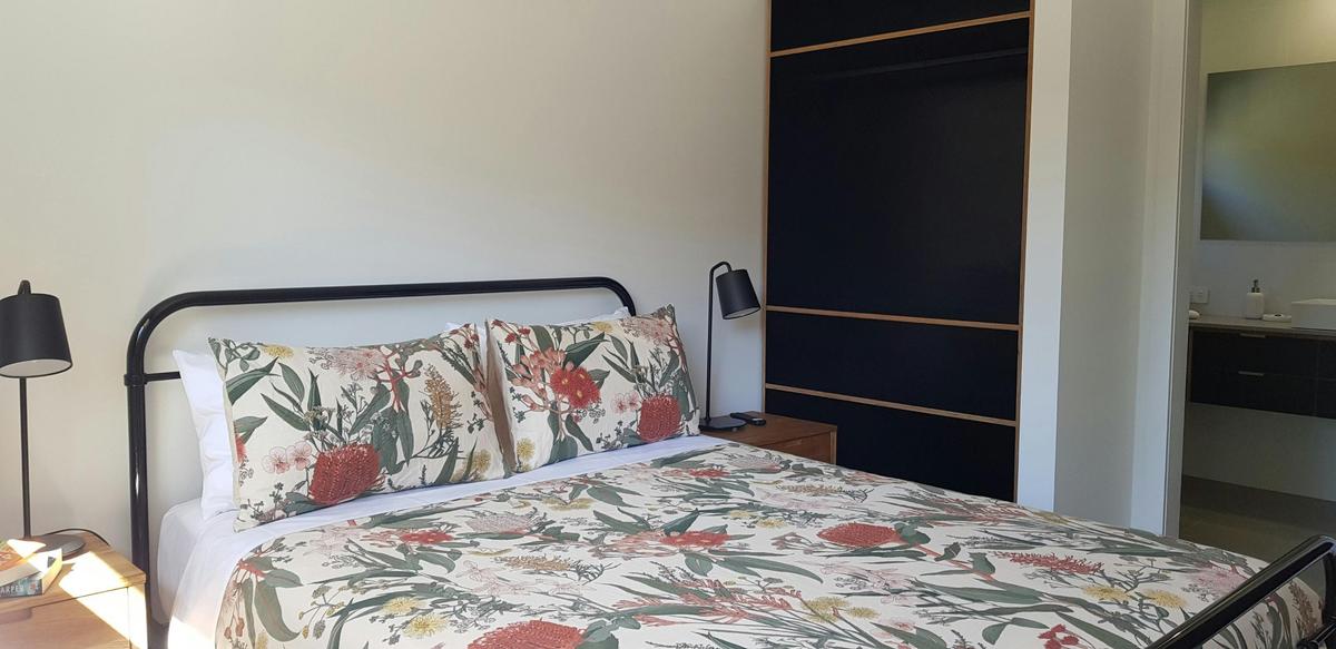 Queen bed with beautiful bedding and quality mattress.