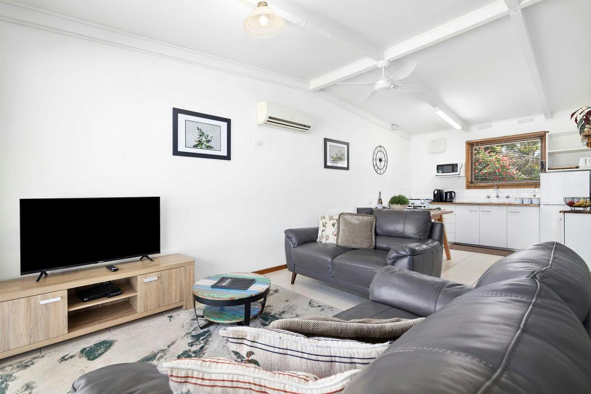 a lounge room with two couches and a television