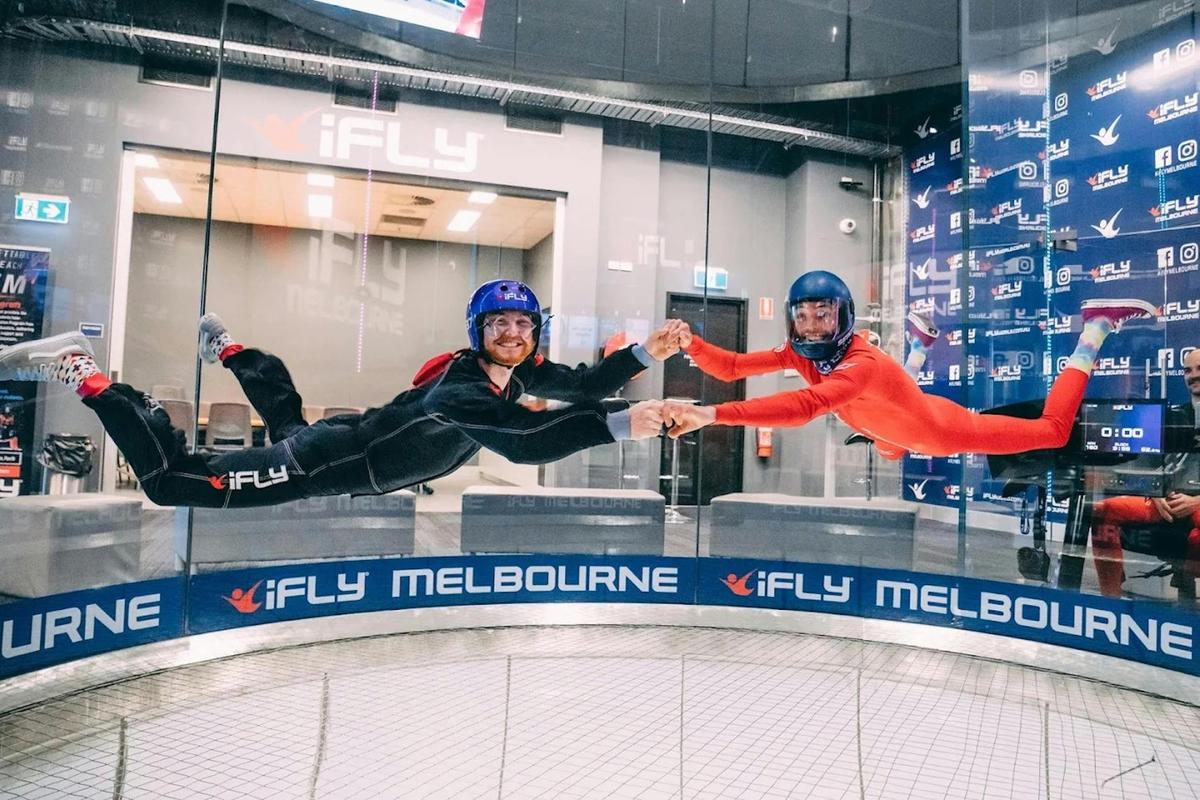 Flyer being supported by instructor mid-flight