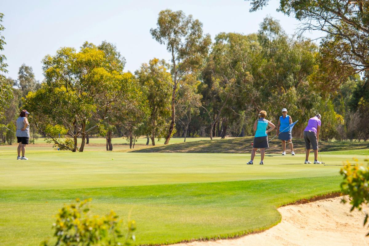 Group of women playing golf on a tee