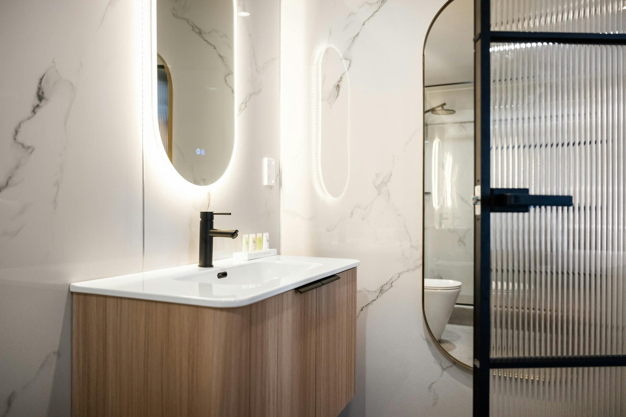 A bright bathroom with a vanity in view