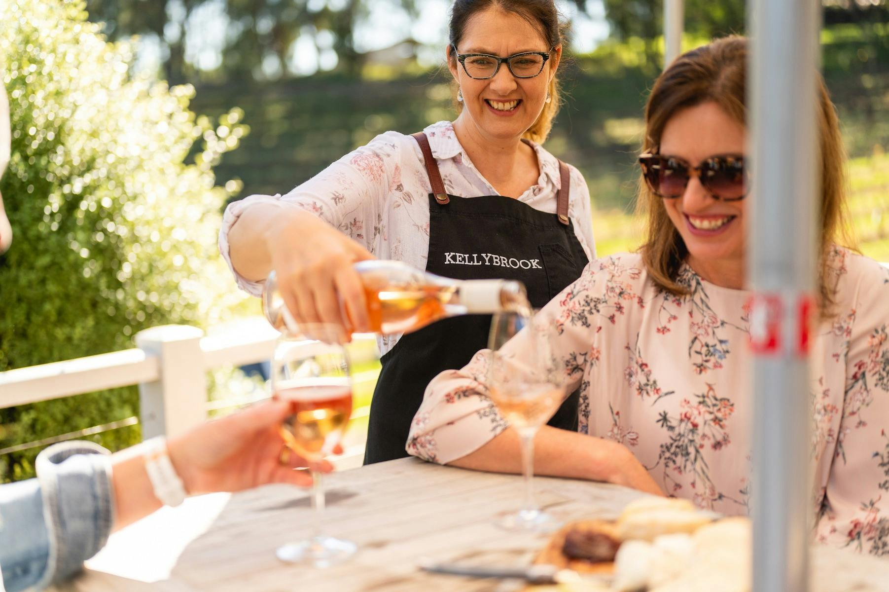 Jenny Kelly pouring rosé on the terrace