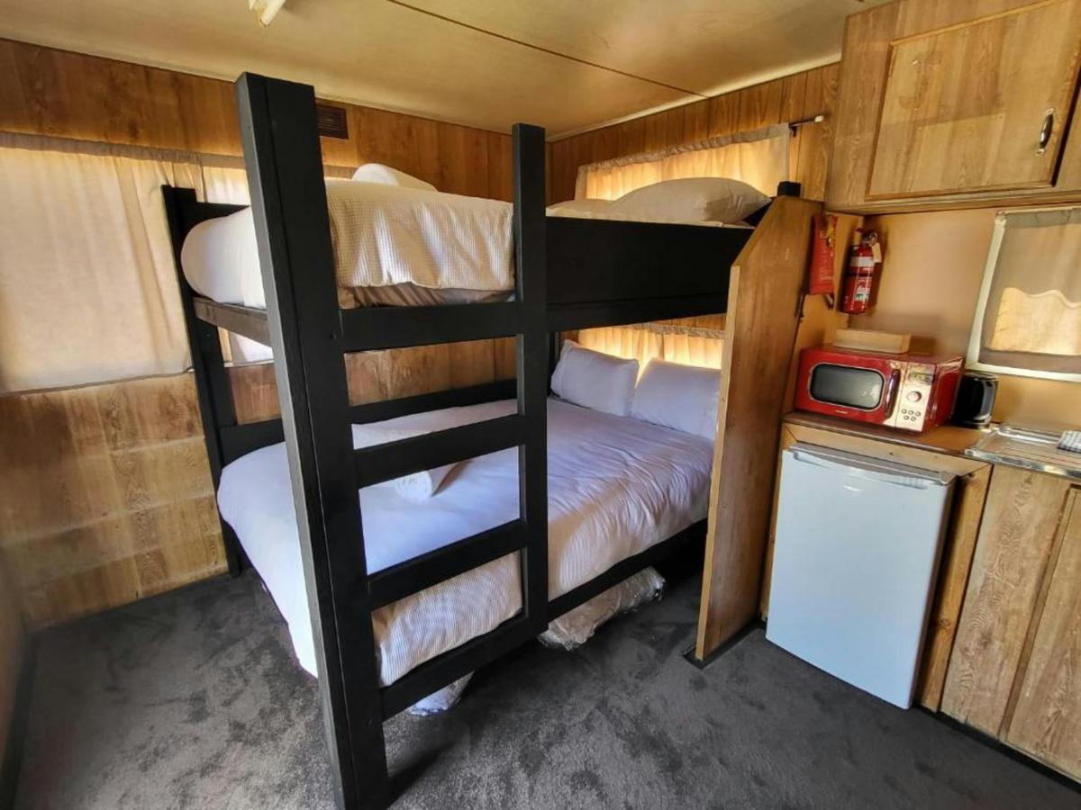 Cabin 5 offers comfortable bunk beds and a functional kitchenette
