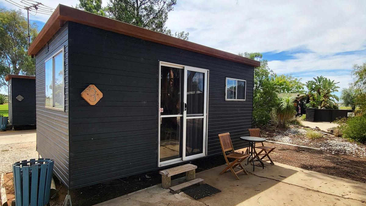 Black cabin 3 with outdoor seating at Kangaroo Lake Hotel Motel