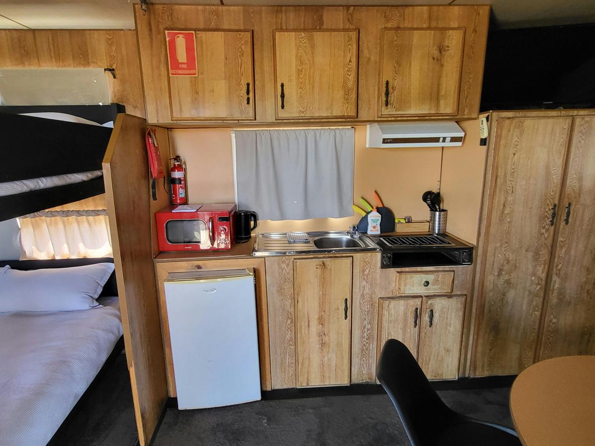 Cabin 3 kitchenette with wooden cabinets at Kangaroo Lake Hotel Motel