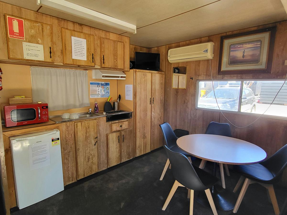 Fully equipped kitchenette and dining area in a cabin at Kangaroo Lake Hotel Motel Accommodation