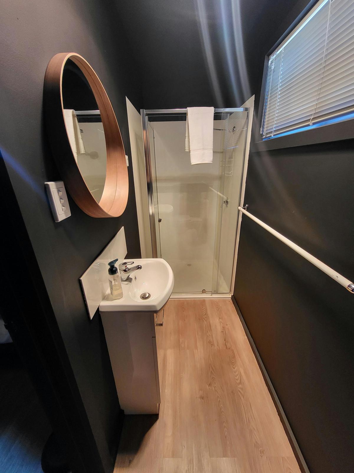 The sleek bathroom in Cabin 11 offers a comfortable and modern space