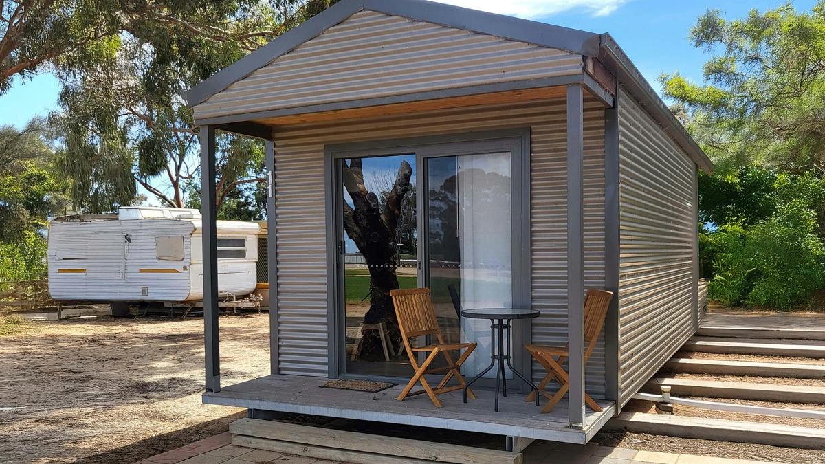 Relax outside Cabin 11 on its cozy porch, complete with seating for two