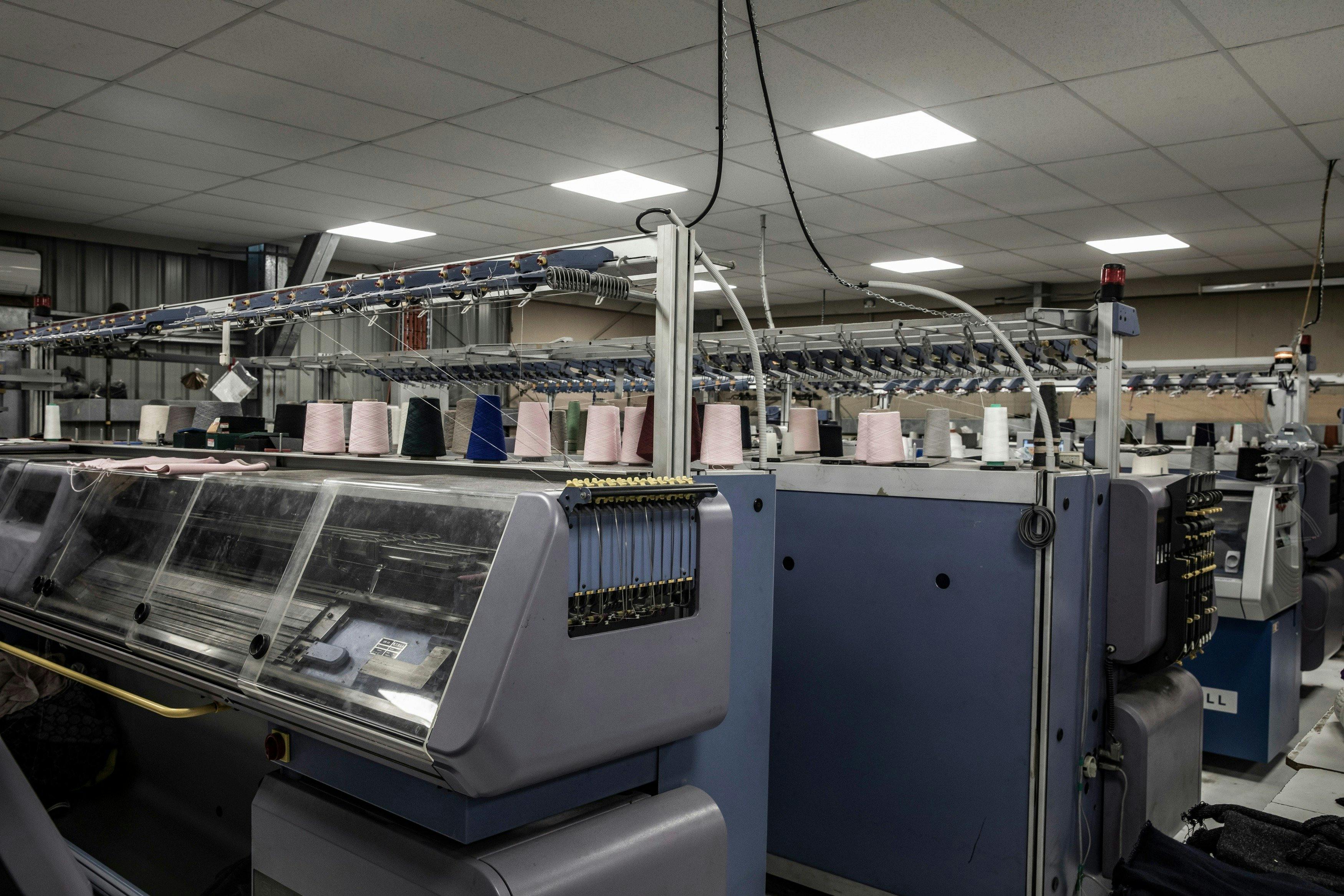 Rows of flatbed knitting machines in the factory