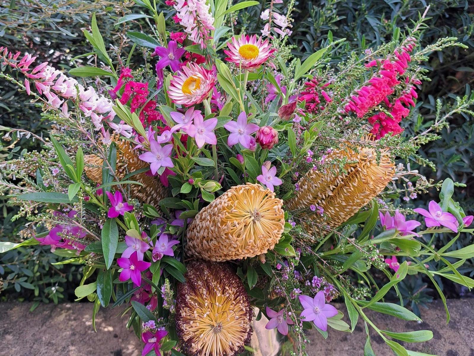 There is year round flowering at Karwarra. A vase displaying beautiful autumn colour at Karwarra.