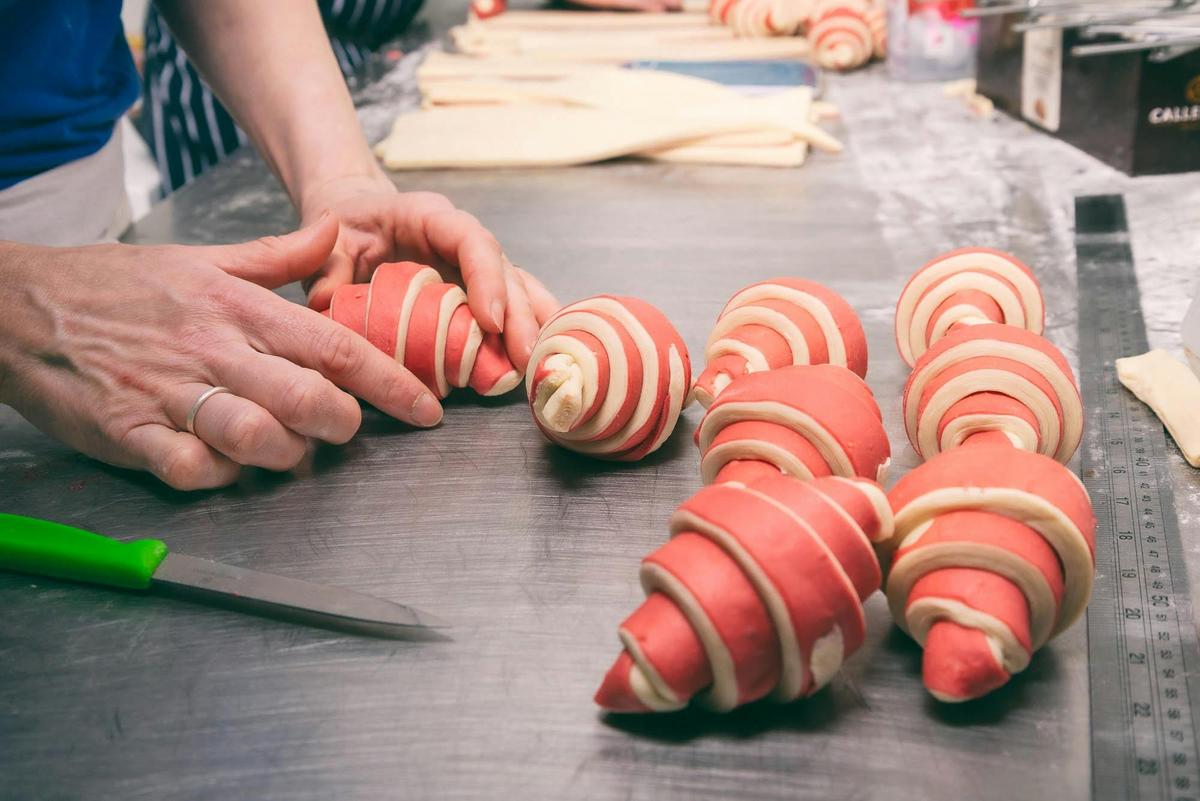 Head baker, Miek, creating sourdough raspberry croissants from her shed bakery