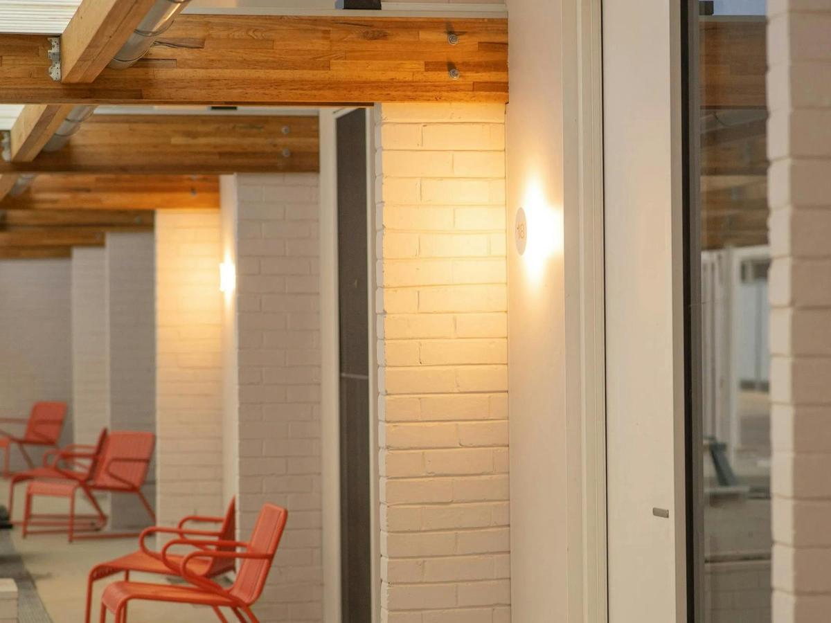 exterior of the Kar-Rama Hotel Superior King Room with red chairs