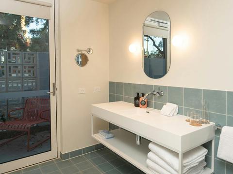 Kar-Rama Hotel Executive King Terrace with sink, mirror and door leading outside