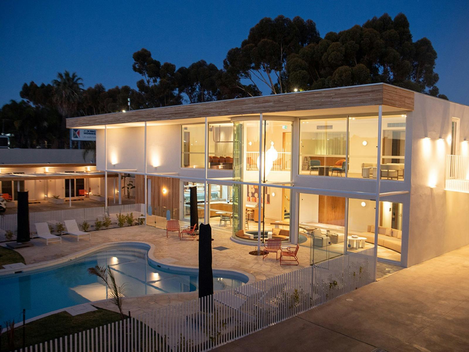 exterior of Kar-Rama during night time with the lights on and the pool