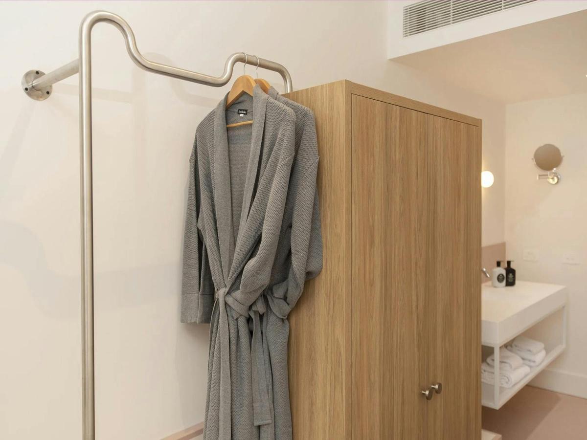 bathrobes on a hanger in the Kar-Rama Hotel Superior King Room