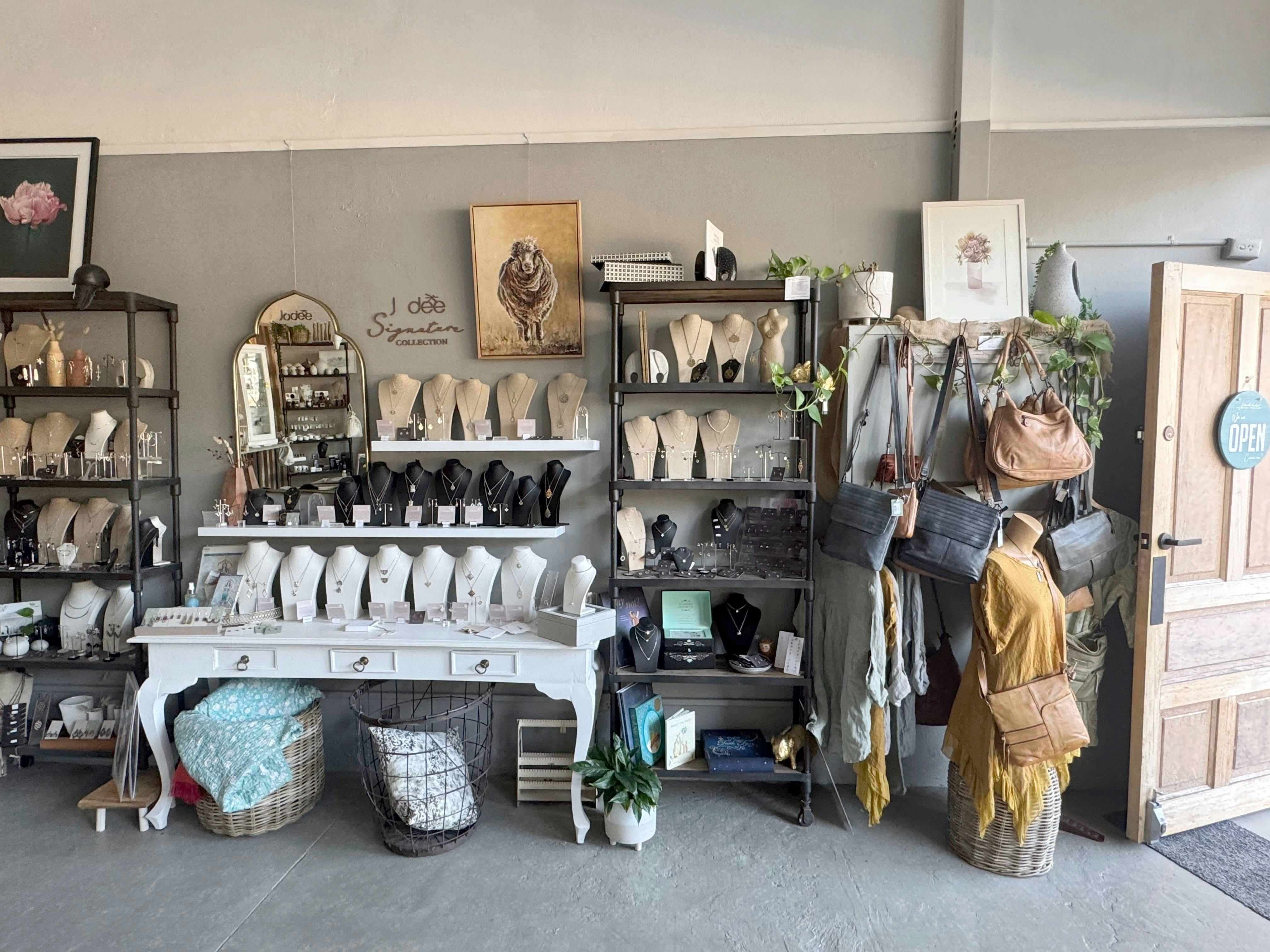 Wall of shop jewllery and art works on display handbags and leather goods