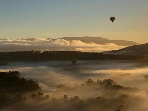 Balloon adventure over picturesque misty hills and valleys