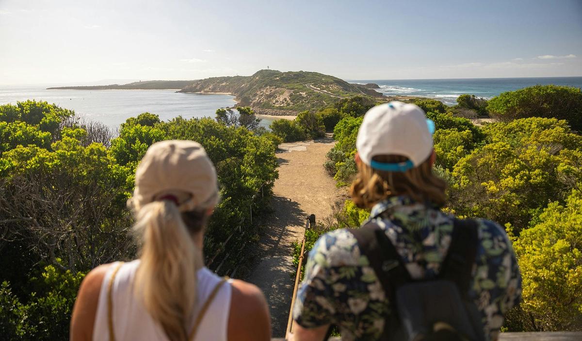 two people wearing caps looking at a  view at Point Napean National Park