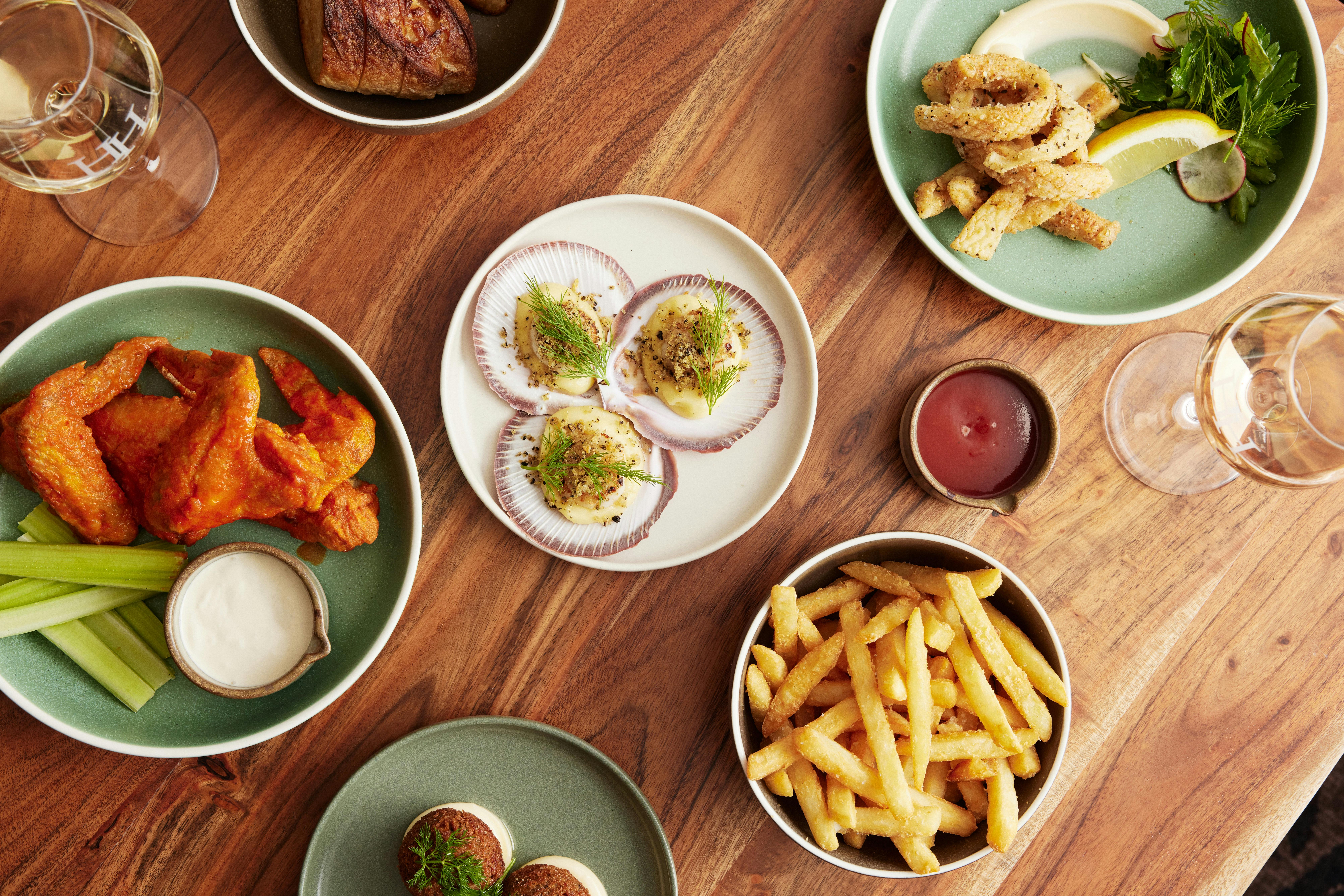 Photo of a the selection of the dishes available, including scallops, chicken wings and calamari