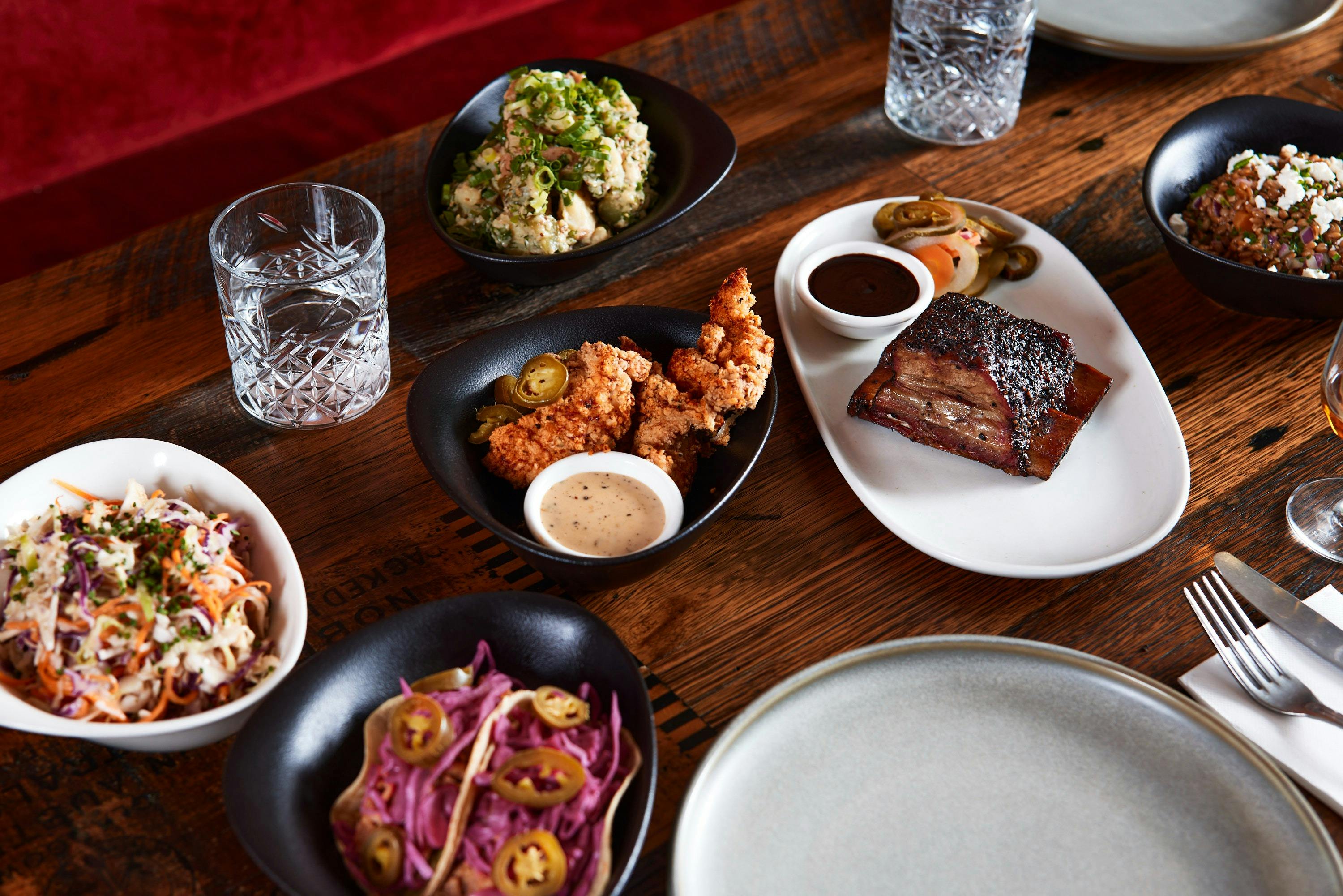 American style barbecue dishes placed on a wooden table