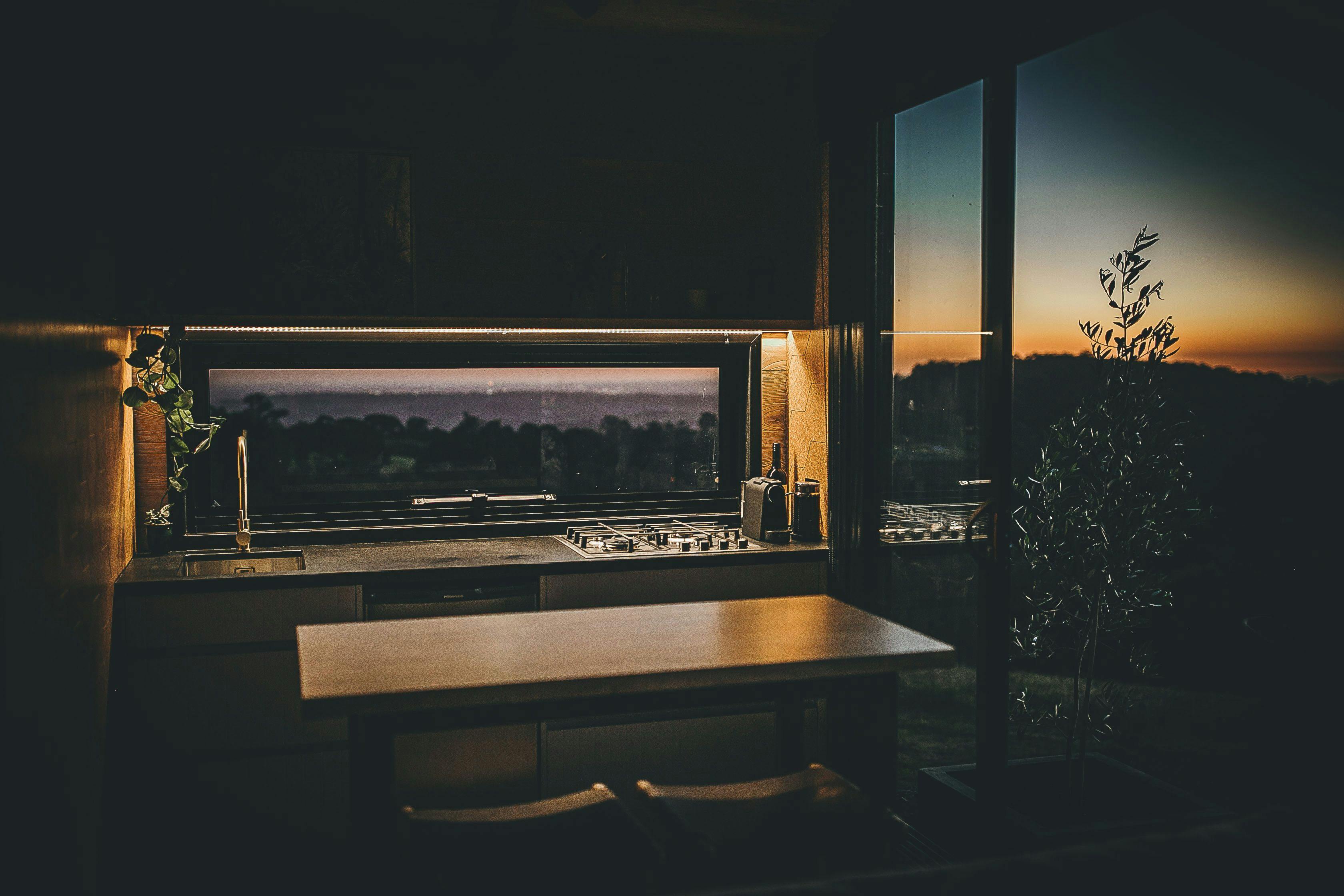 Panoramic views lead onto open plan kitchen, dining and lounge with a gas log fireplace