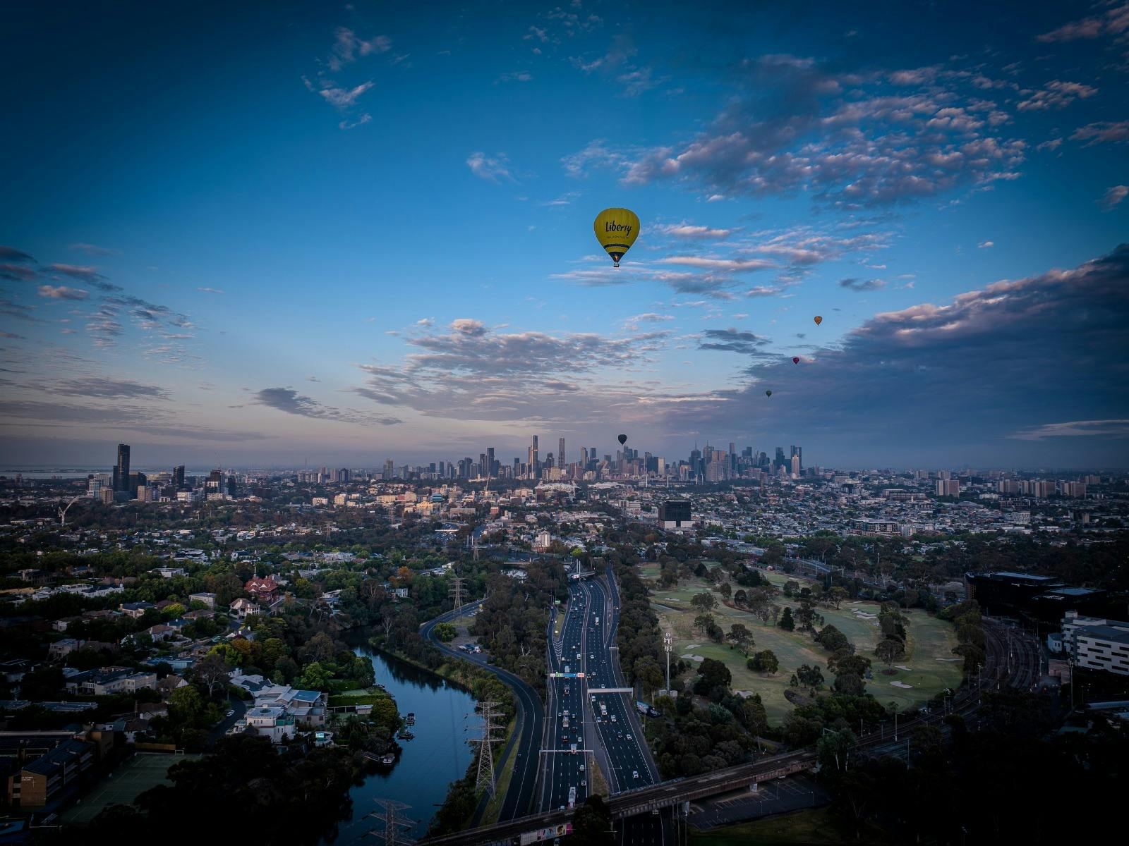 Liberty Balloon Flights’ hot air balloon drifting over the city for a unique aerial experience