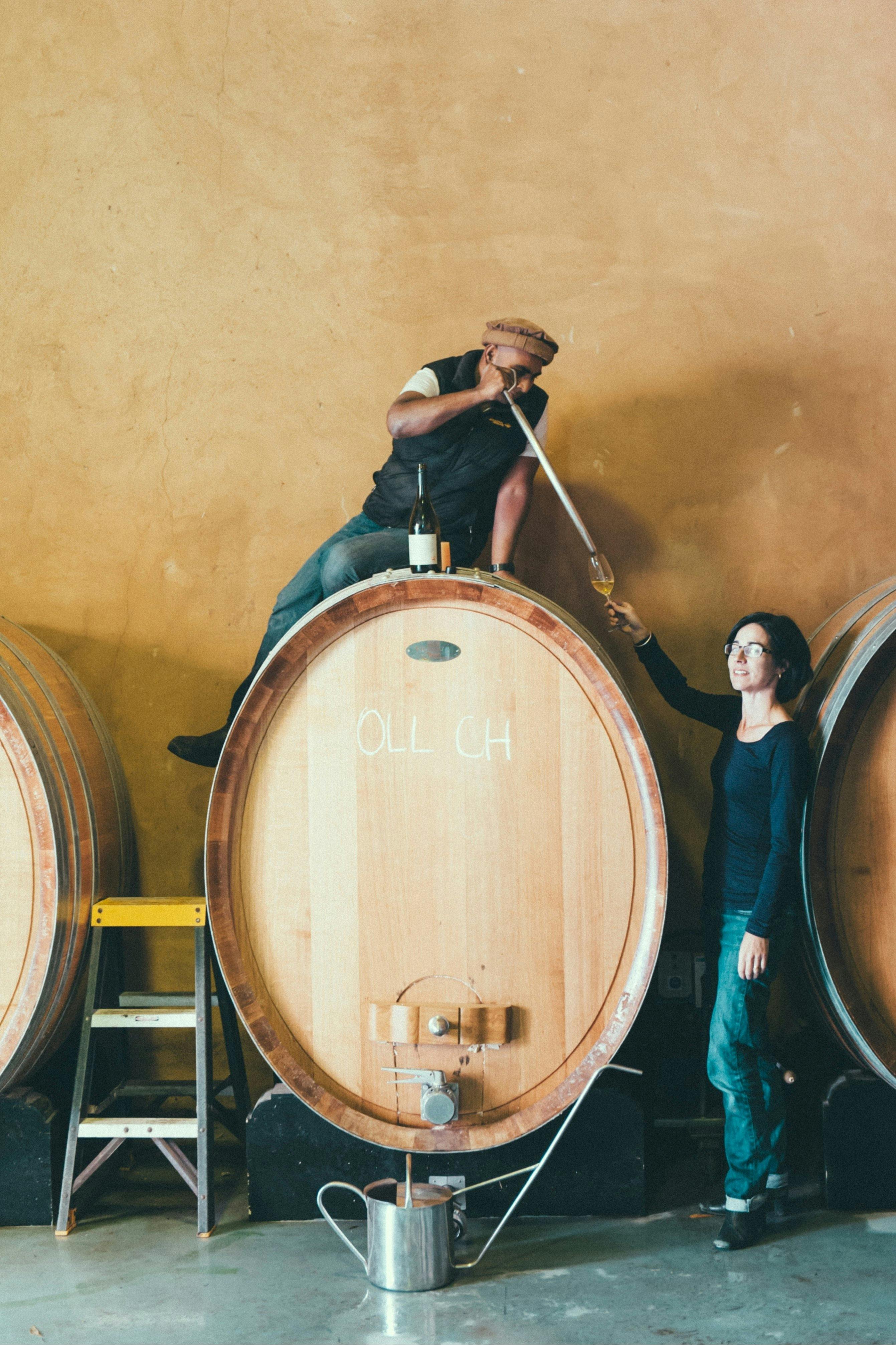 Ray & Maree sampling chardonnay from a foudre