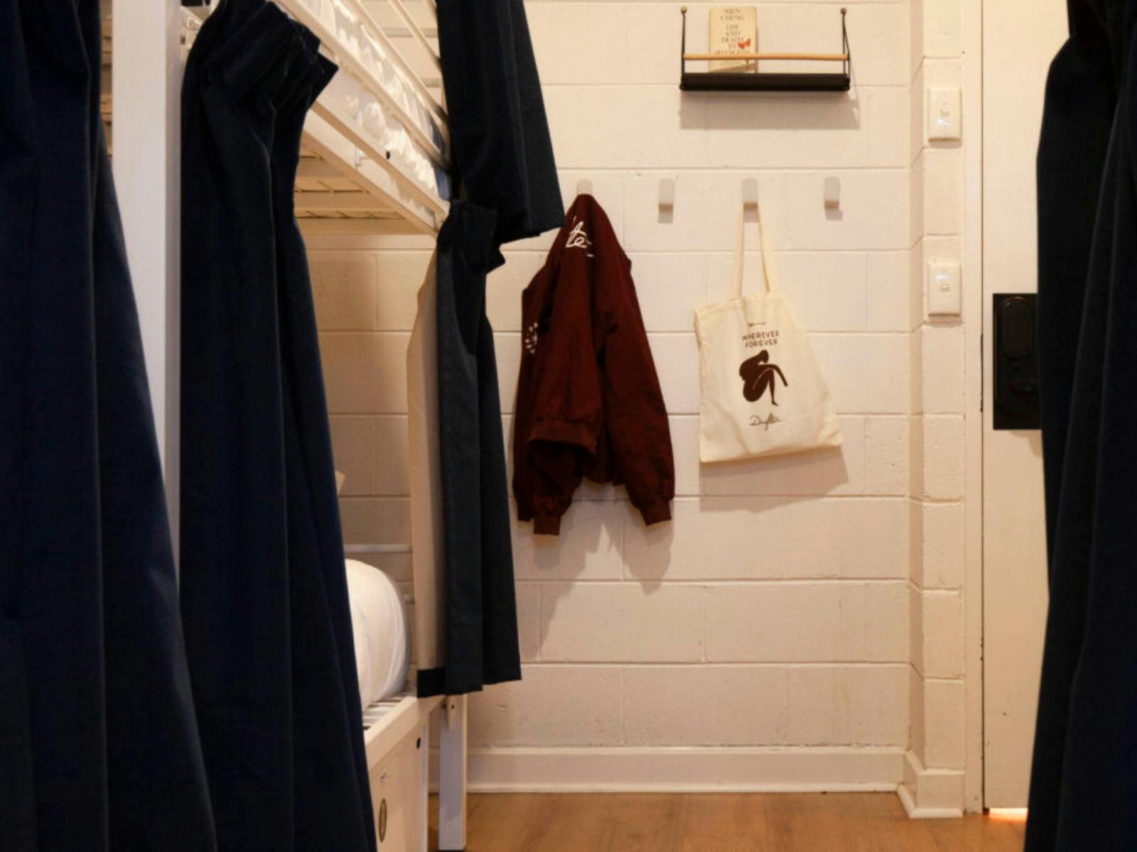 a jacket and a tote bag on a hook